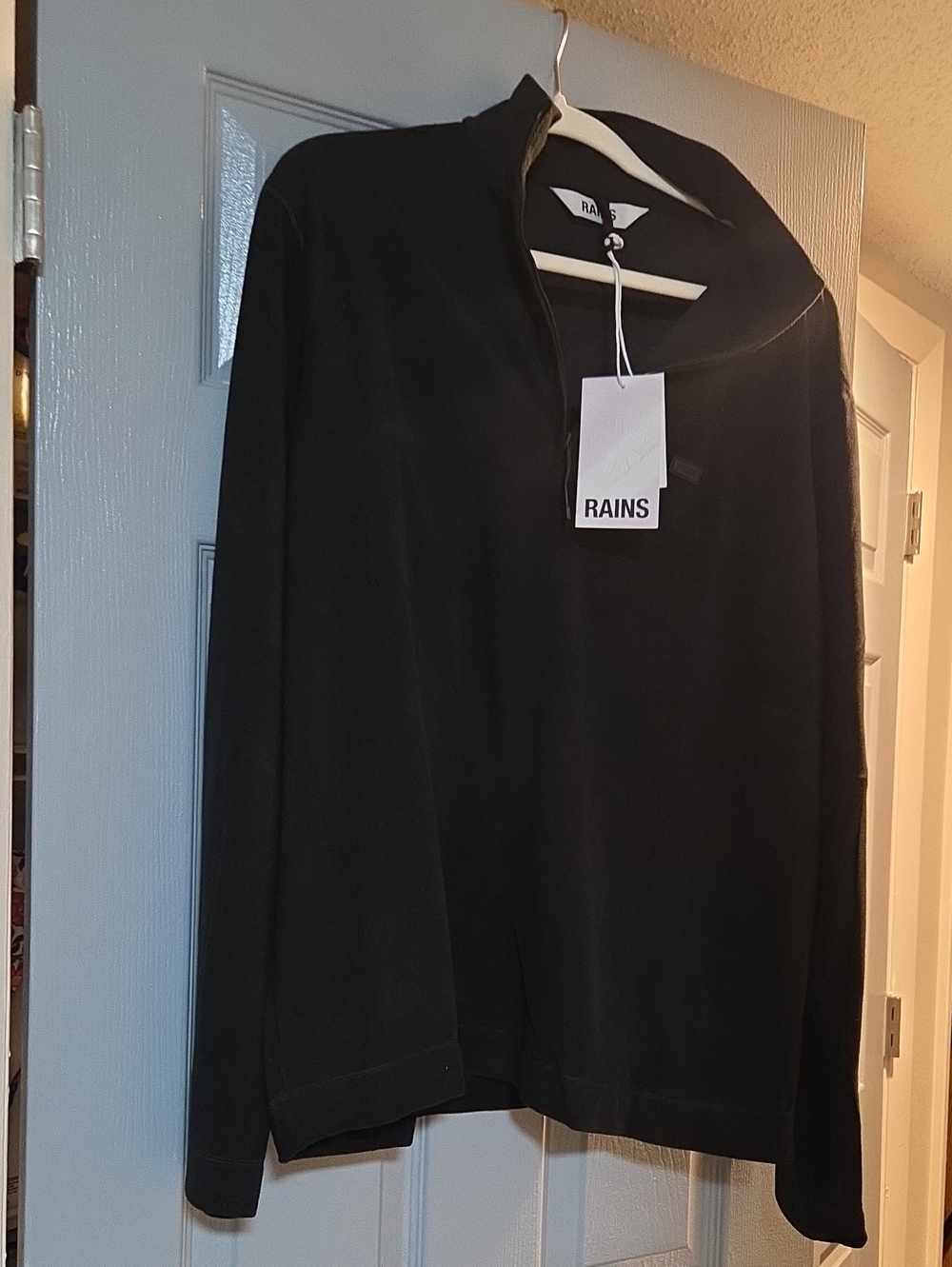 Polyester pullover top, RAINS brand, black long sleeve with collar